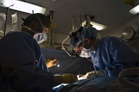 doctors performing surgery in scrubs