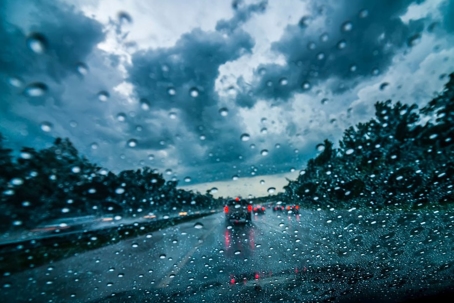 rain on a windshield while driving on the road