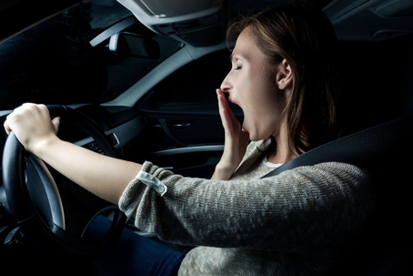 woman yawning while driving