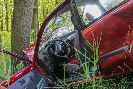 red car in a serious accident into a tree