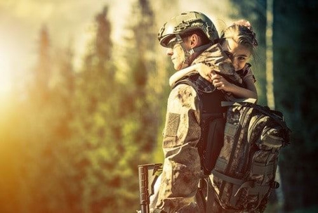 Soldier carrying his daughter