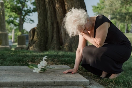 grieving widow at cemetery