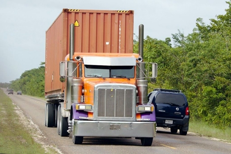 truck passing an SUV on a two line highway