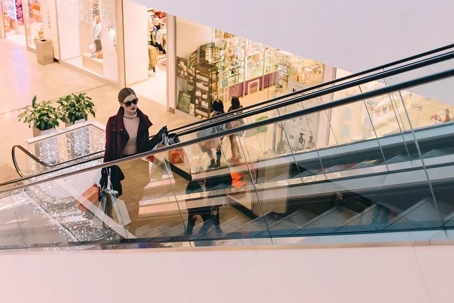 woman going up the escalator