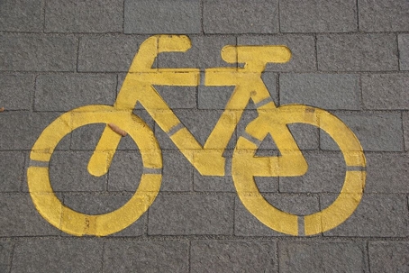 yellow bicycle icon painted on street
