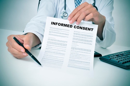doctor holding an informed consent paper