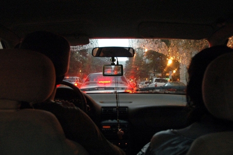 View from inside of a car looking ahead at cars stopped in traffic