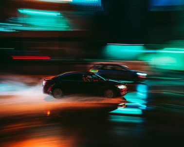 blurry images of two cars with neon lights