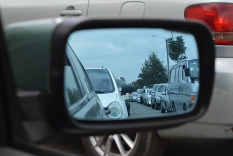 review mirror of car looking at many cars behind it
