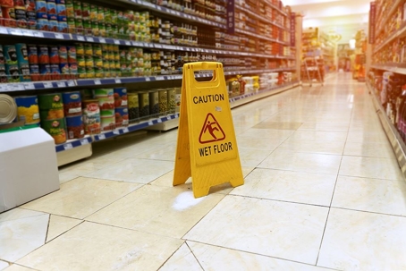 Caution - Wet Floor Sign at grocery store aisle