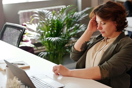 woman at a desk looking at a computer
