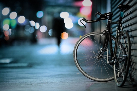 bike leans against a closed metal door on the street