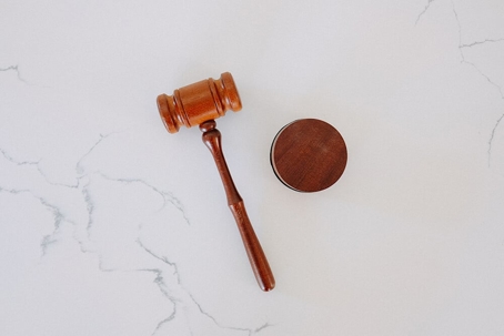 wooden gavel and block on marble tabletop
