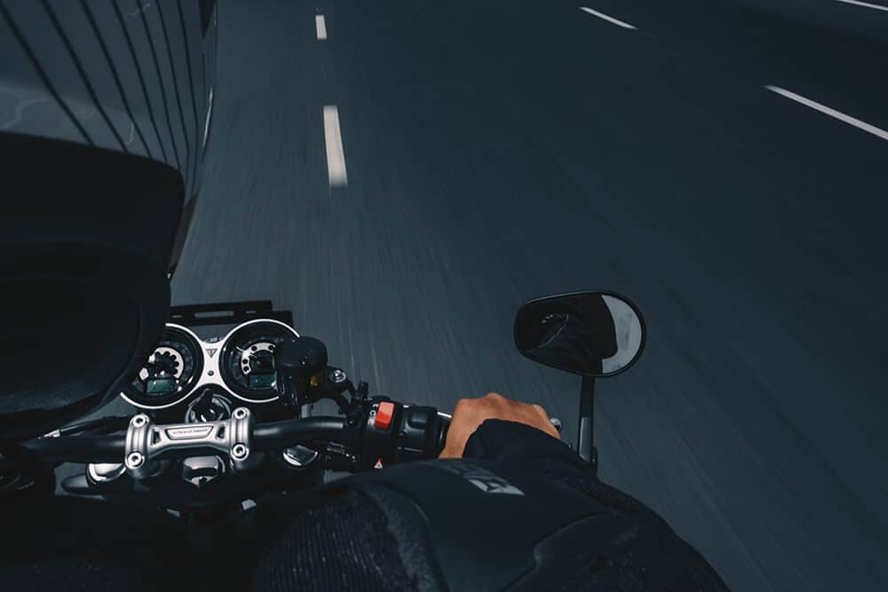 Motorcyclist riding motorcycle on road